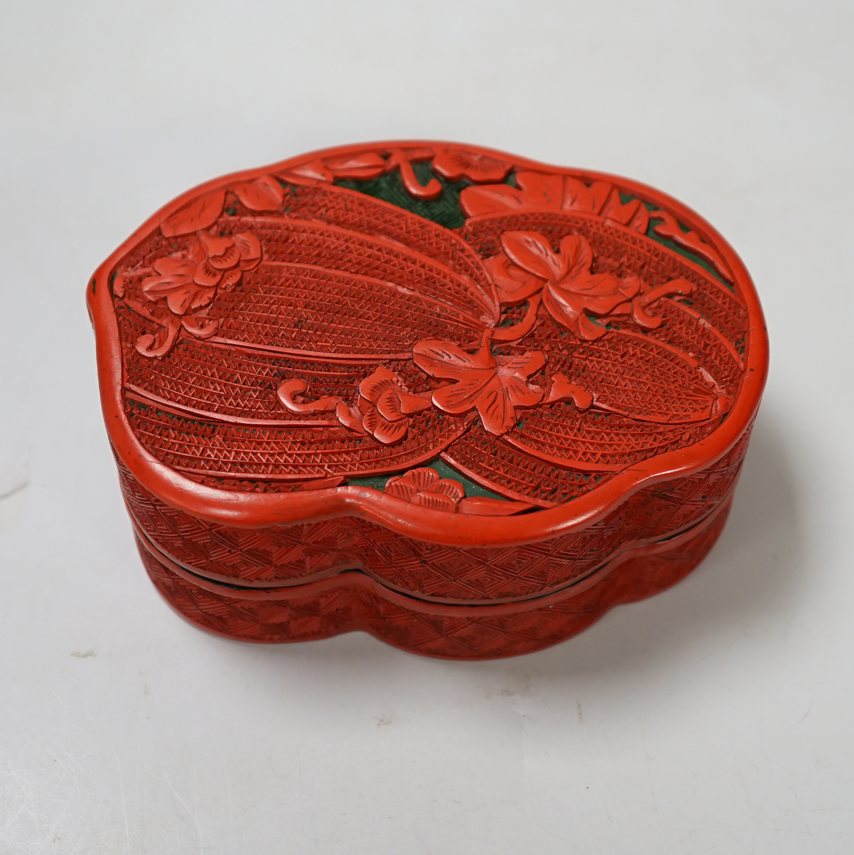 A Chinese cinnabar lacquer box and cover, decorated with bitter melons, 12cm high